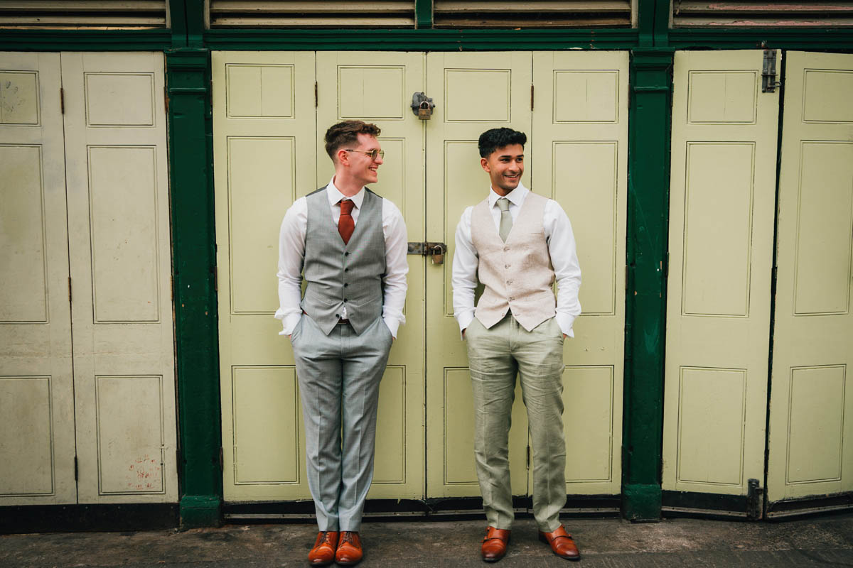 two men pose in their suits for the camera