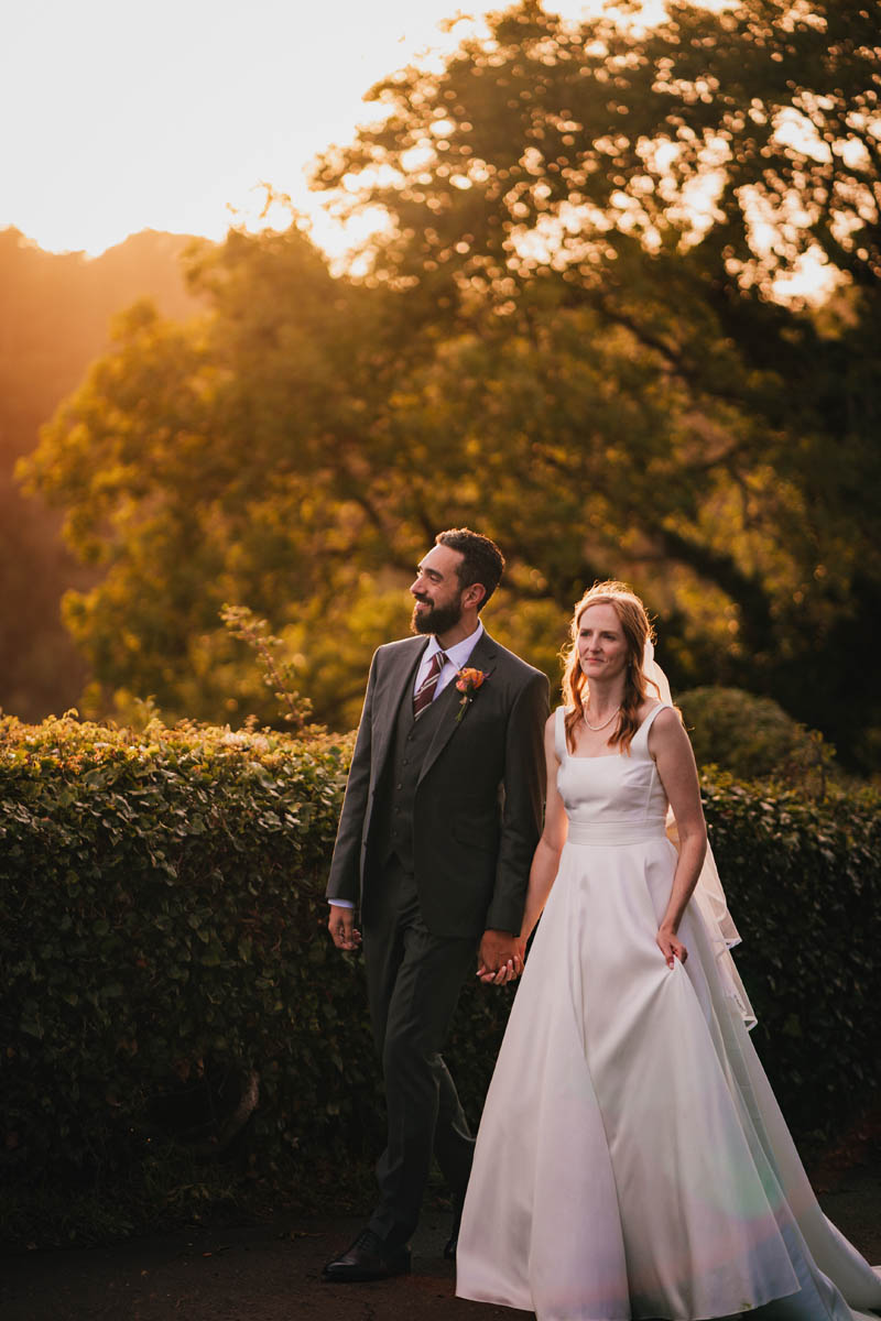 a couple kiss at golden hour on their wedding day