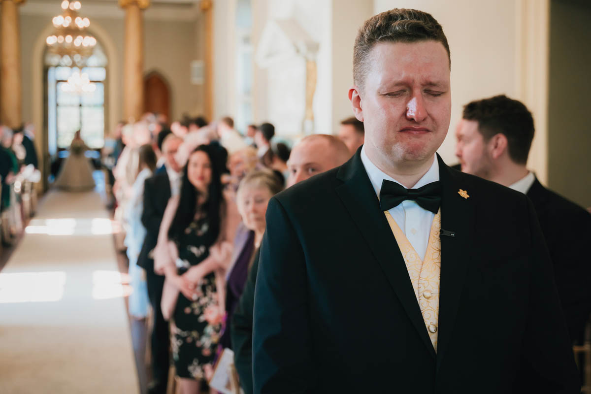 a man looking emotional during his wedding ceremony