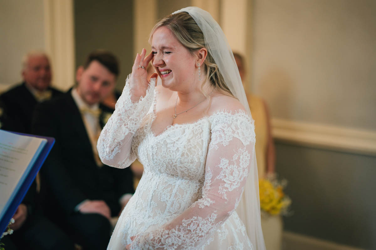 a bride wipes away a tear