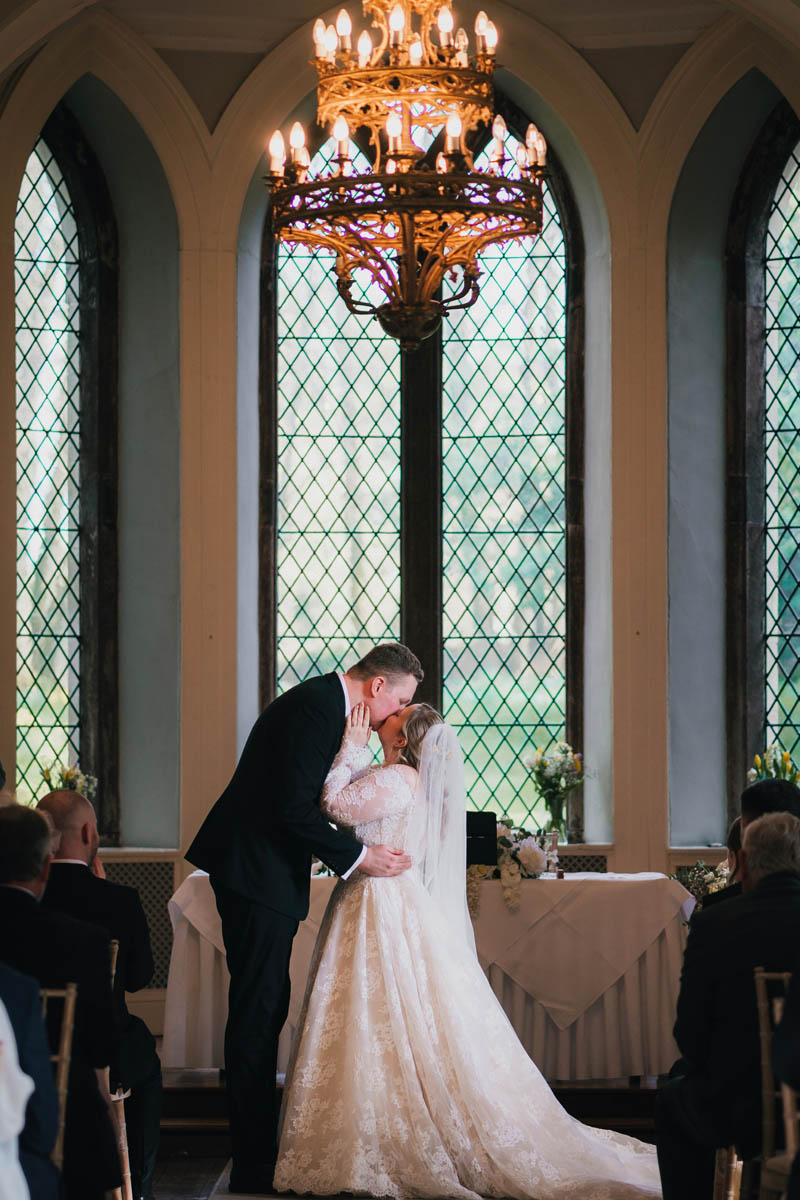 a couple kiss at their wedding