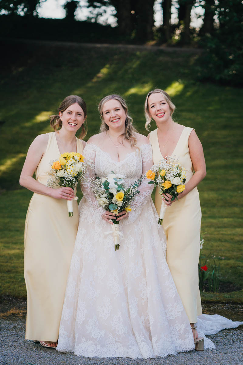 the bride and her maids of honour holding their wedding bouquets