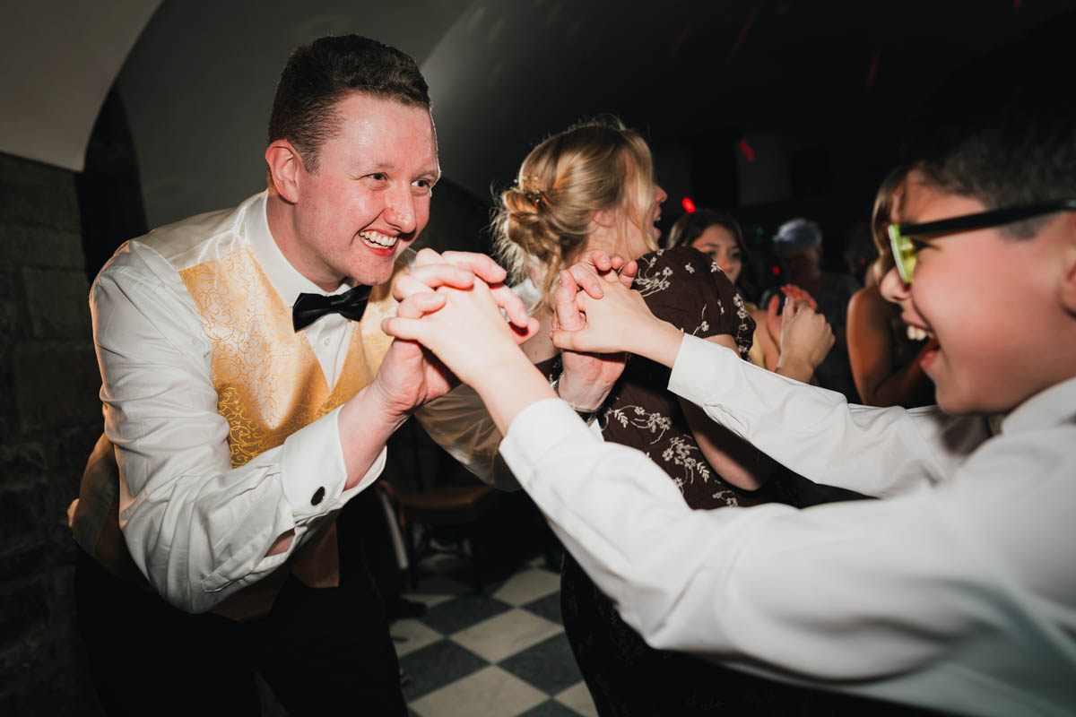 the groom and a wedding guest dance