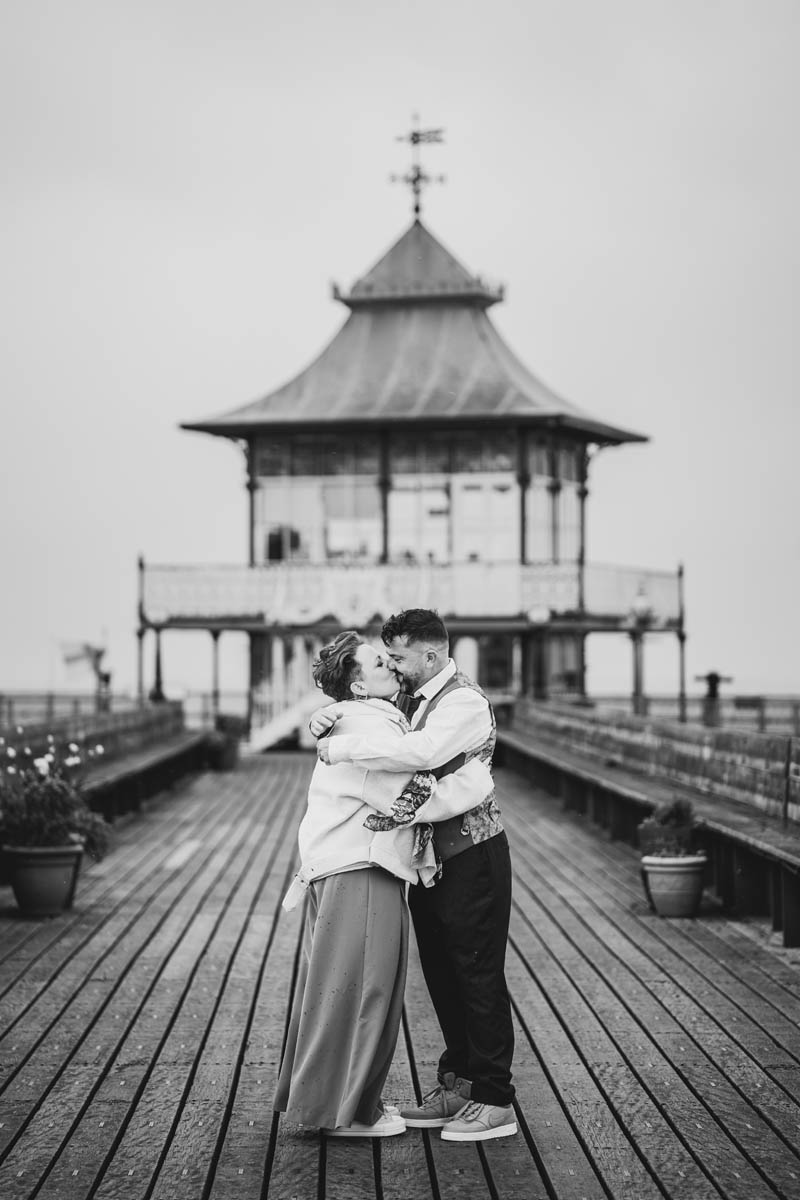 A newly married couple take time for a portrait picture on Clevedon Pier