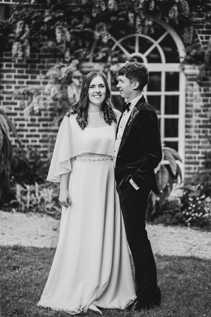 a black and white portrait of a bride and groom at Goldney Hall